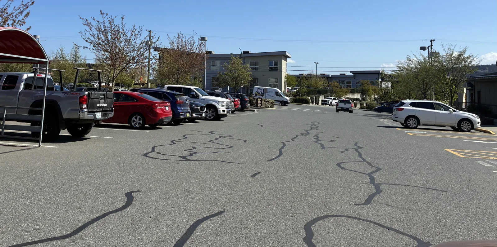 Crack sealing across the Country Grocer Bowen parking lot.