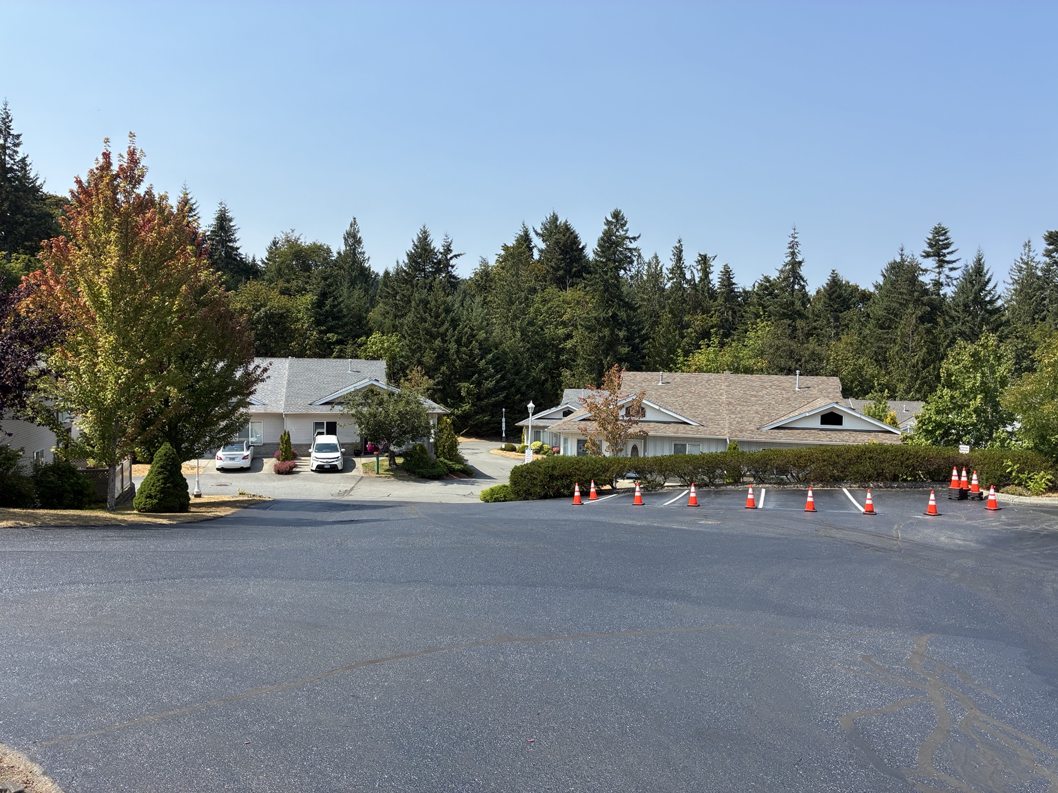 Sealcoated asphalt area in Ladysmith, with parking stalls and traffic cones.